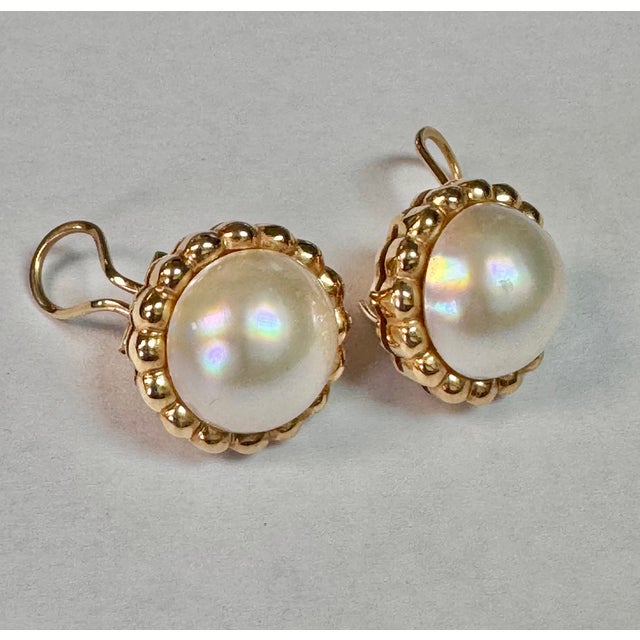 14K Yellow Gold Vintage Mabe Pearl Earrings. Earrings each feature a Mabe pearl framed by a delicate scalloped bezel,...