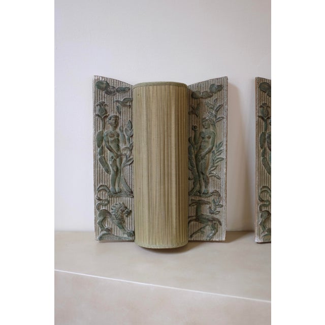 Stunning pair of stoneware lamps by Erling Valldeby for Nordiska Kompaniet. The Wall lights depicts Adam and Eve on each...