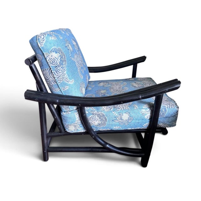 Rattan/bamboo lounge chair with new foo dog chinoiserie upholstery. In the manner of Ficks Reed, this stylish chair works...