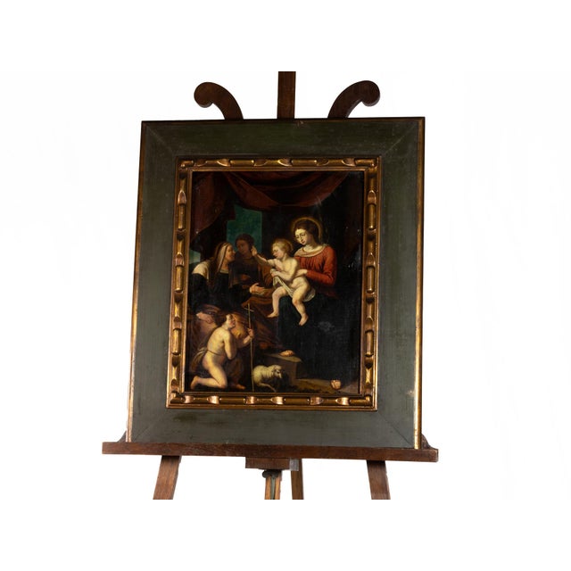This 18th-century Flemish oil on wood painting depicts the moment of adoration of the Child Jesus, in the loving arms of...