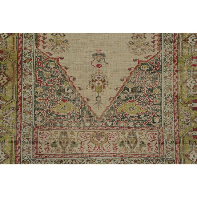 Hand-knotted in luminous natural silk circa 1920-1929, this exquisite 4x6 antique Turkish rug is a masterpiece of design....