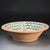A large Spanish hand-painted earthenware lebrillo bowl executed in the traditional Fajalauza style. The bowl is decorated...