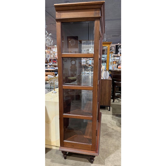A timeless blend of craftsmanship and function, this Baur two-door display cabinet offers refined storage with a classic...