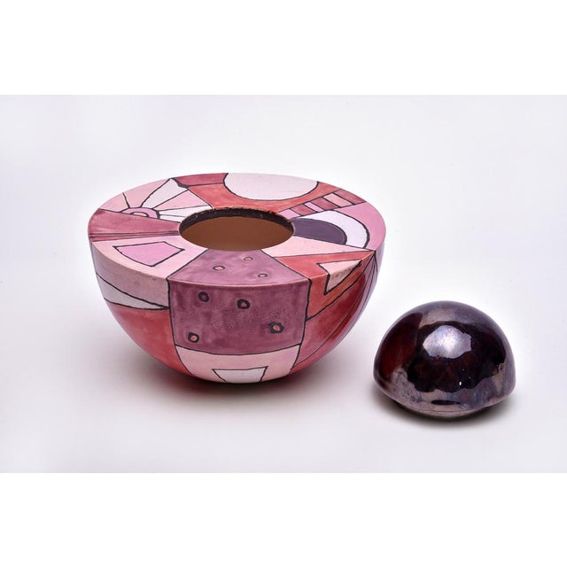 This round vase-like multicolored ceramic urn is a unique piece crafted with care and passion. This beautiful memorial...
