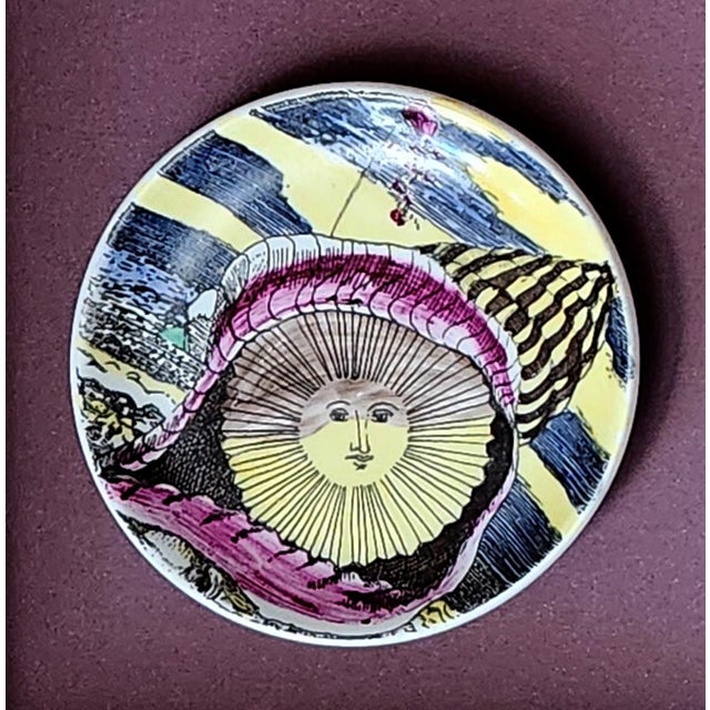 Piero Fornasetti “12 Mesi, 12 Soli” Porcelain Coaster, August, Sun in a Seashell, Framed Milan, circa 1960–1965 (One of...