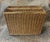 Circa 1990s woven wicker magazine rack with two large compartments. The top and bottom edges and four corners are...