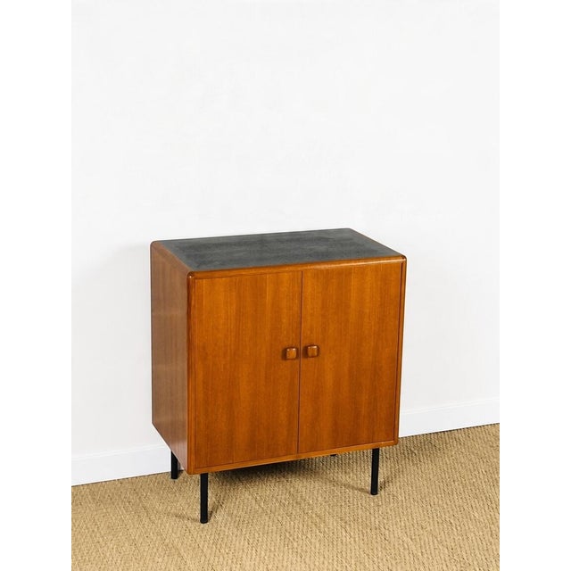 Vintage Scandinavian teak sideboard/buffet, dating from the 1970s, featuring two storage doors with shelves. Black metal...