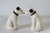 Pair of vintage black and white dog salt & pepper shakers. No makers mark. Cork may need to be replaced. No chips or cracks.