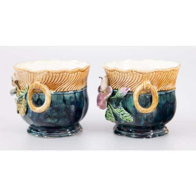 A lovely petite pair of antique French majolica barbotine floral cachepots or jardinieres, circa 1880. Decorated with pink...