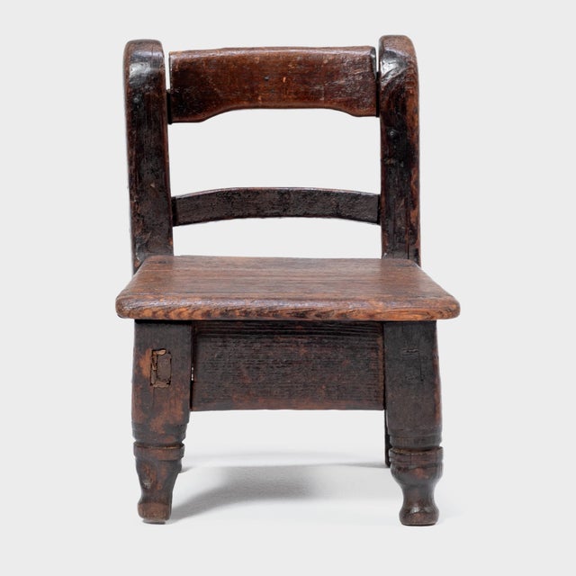 Crafted in the early 20th century, this petite Guatemalan children's chair charms with its playful asymmetry and richly...