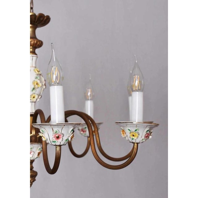 Eight-arm chandelier made of polished brass with Capodimonte porcelain. Very high quality chandelier. Completely restored...