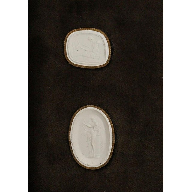 A framed collection of 6 Grand Tour intaglios dating from the early 19th Century. The subjects from Classical Antiquity...