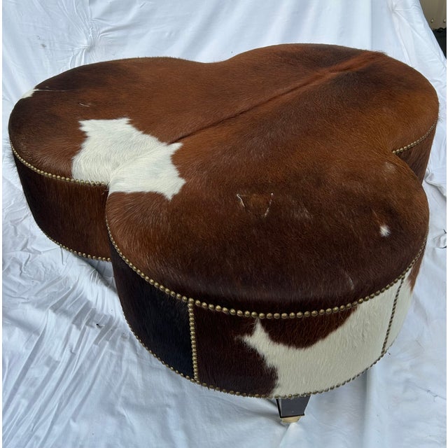 English Vintage Cloverleaf Cowhide Ottoman With Brass Casters & Nailhead Trim For Sale - Image 3 of 7