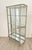 A brushed steel mirrored French display case / vitrine, circa 1920. On turned tapered Louis XVI–style feet. An elegant,...