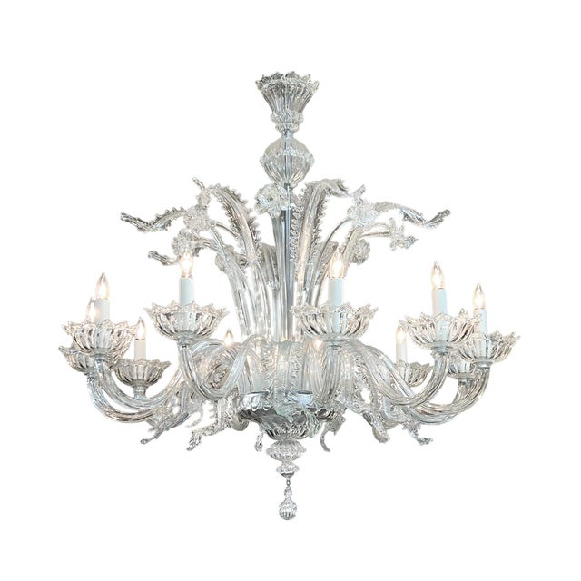 the ornate chandelier featuring a fountain-like and botanical silhouette; the central stem terminating in a large bowl...