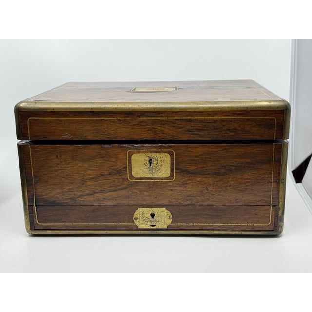 A nice example of a Victorian English vanity traveling case. It is crafted of rosewood and features glass containers with...