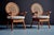 Pair of 1960s lounge chairs with round cane backs, woven rattan seats and sculptural bamboo-style frames. The chairs...