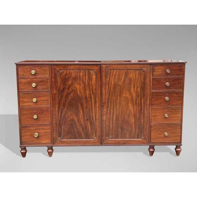 A substantial, handsome piece of useful furniture. A George III period mahogany Gentleman's low press attributed to...