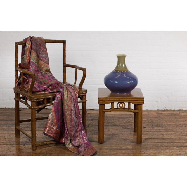 A Prem Collection ceramic artisan hand crafted vase with periwinkle, olive green glaze, brown dripping motifs and trumpet...