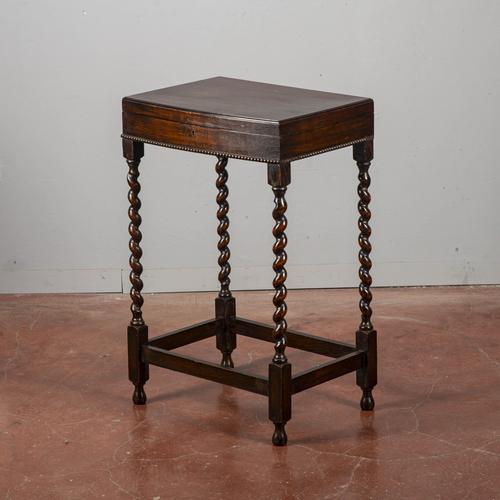 This charming antique side table is a classic example of period furniture, characterized by elegant spiral-turned legs, a...