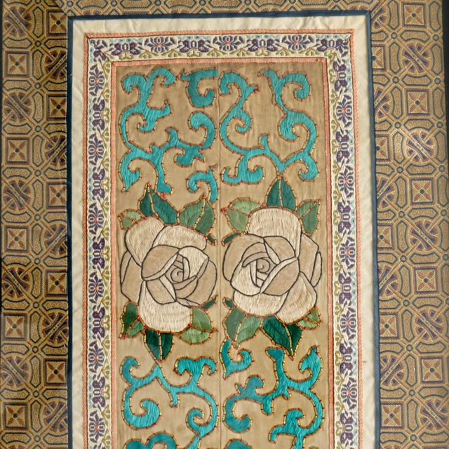 A tightly hand embroidered pair of sleeve bands that have been framed together with brocade edges. A colorful pair of...