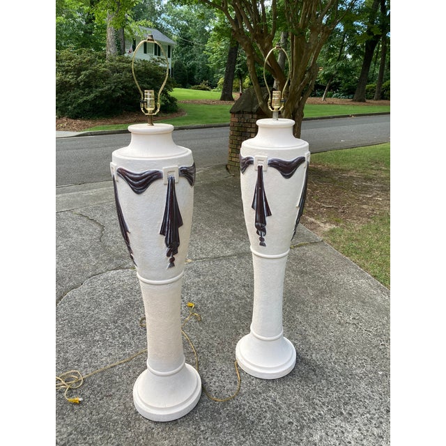 A well-preserved pair of post-modern era neoclassical revival plaster floor lamps dating from the 1980s.
