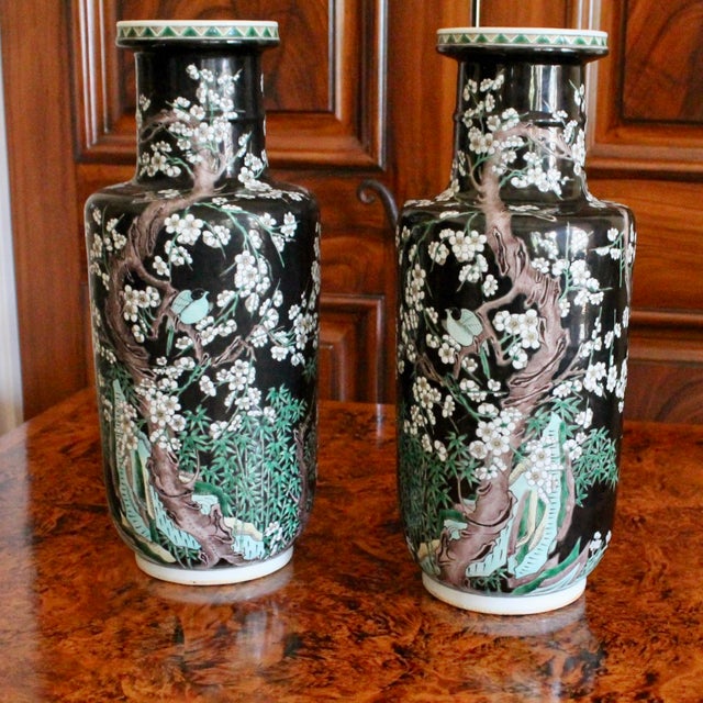 A fantastic pair of detailed and dramatic porcelain vases, the main decorative element comprised of mirrored flowering...