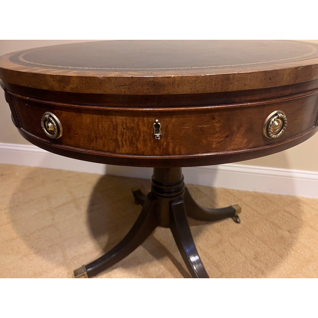 Offered is a round drum table by Henredon. This piece features a leather top with a dovetailed drawer. This piece is part...