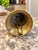 Charming vintage brass hand bell featuring a unique sculptural figural-style handle and classic flared bell shape. Simple...