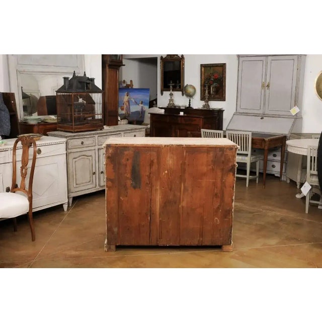 A Swedish Gustavian period wooden sideboard from the late 18th century with original paint and distressed patina. Created...