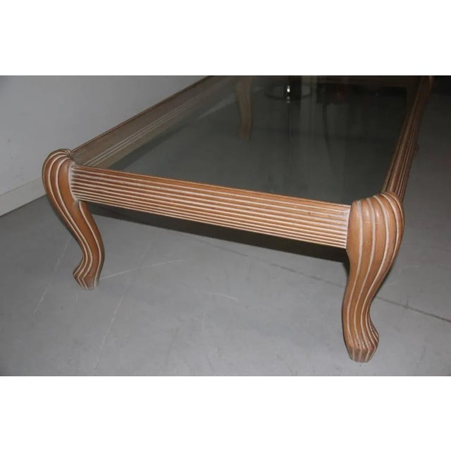 This carved and lacquered 1970s coffee table is in the style of Tommaso Barbi.