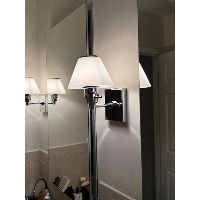 Pair polished chrome Nessen Lighting sconces made out of brass.