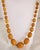A striking antique graduated bead necklace dating to circa 1930, composed of richly coloured amber-tone beads displaying...