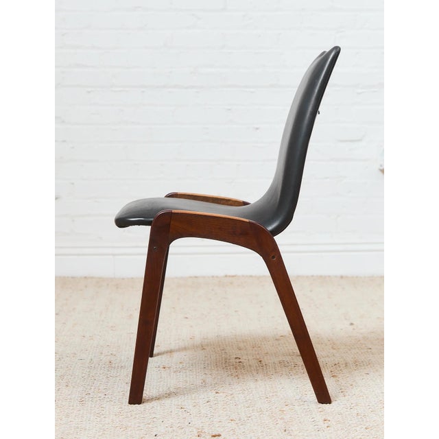 With its modern profile, natural wood legs, and stylish frame, this dining chair is sure to be an eye-catching piece for...