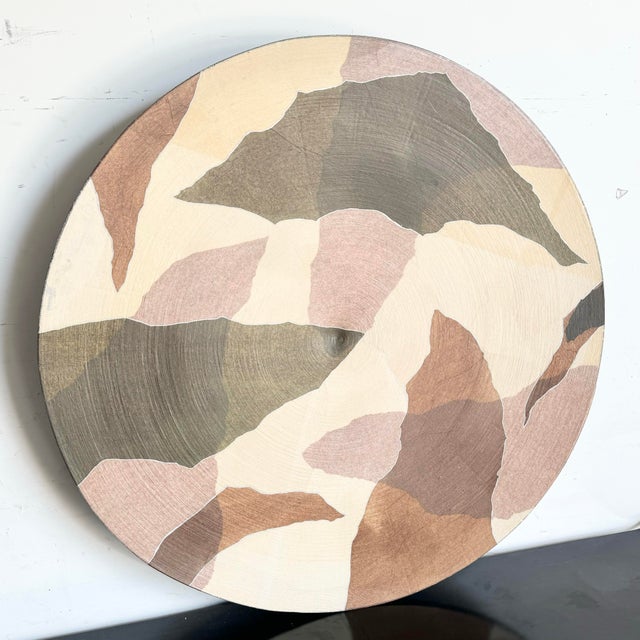 This large decorative plate features an abstract design in soothing shades of brown and tan, crafted from layers of...