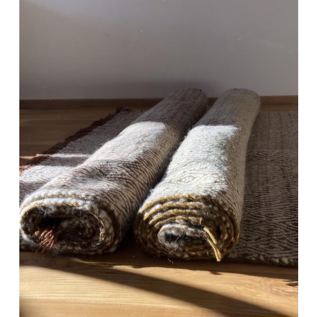 This elegant pair of matching handwoven wool rugs brings timeless bohemian warmth and subtle geometric sophistication to...