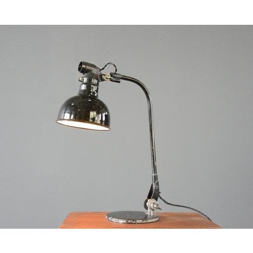 Rademacher Table Lamp Circa 1920s. Vitreous black enamel shade - Articulated curved arm - Cast iron base - Made by Ernst...