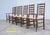 Beautiful vintage set of six English oak ladder back dining chairs with rush seats. There are two captain chairs and four...