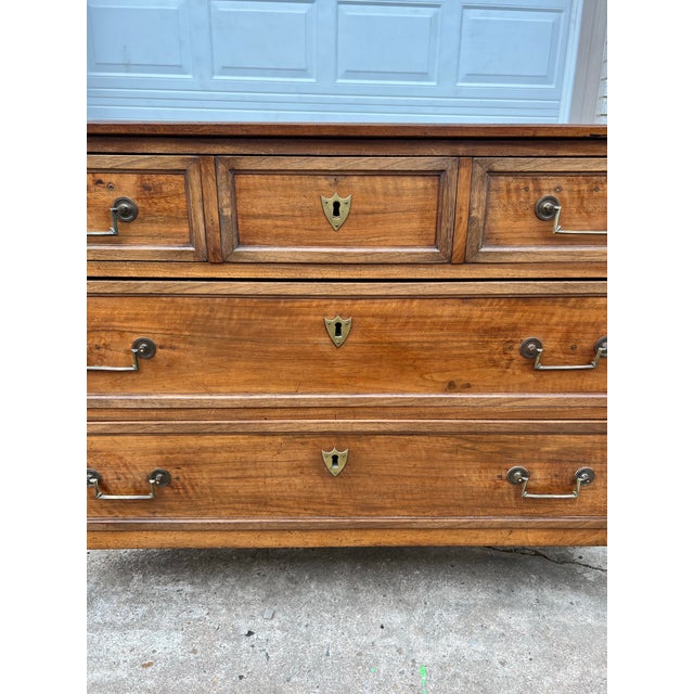 Elegant French 19th-century Louis XVI chest of drawers in richly figured mahogany, featuring three drawers, tapered legs,...