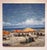 This oil on canvas depicts a vibrant beach scene, filled with colorful orange and yellow umbrellas that dot the sandy...