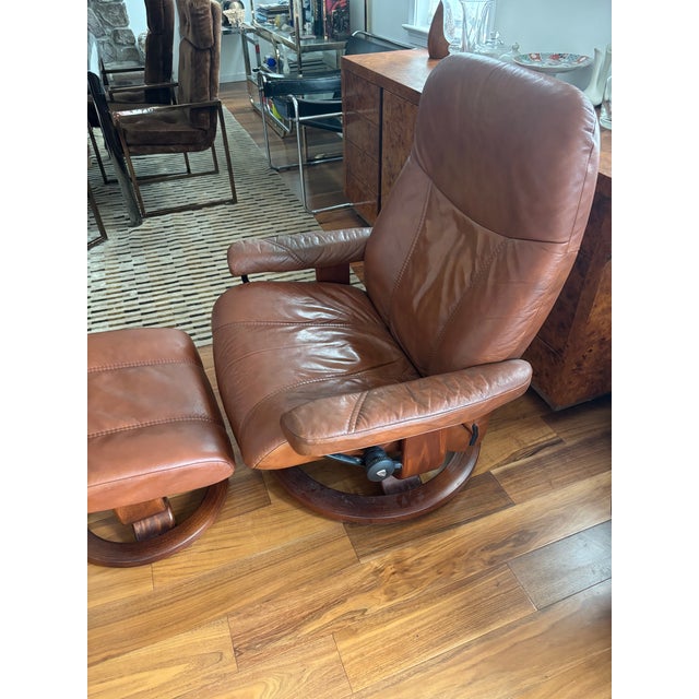 This iconic Stressless lounge chair and matching ottoman by Ekornes represent the pinnacle of Norwegian ergonomic design...