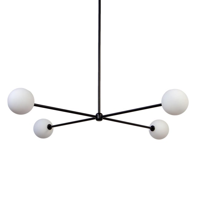 Four glowing globes in graceful formation. The Globe 4 is bold, modern, and full of harmony.