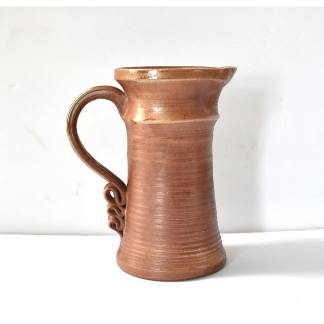 A vintage, art studio pottery, reduction-fired brown stoneware pitcher by Oregon ceramicist Pamela Regentin.