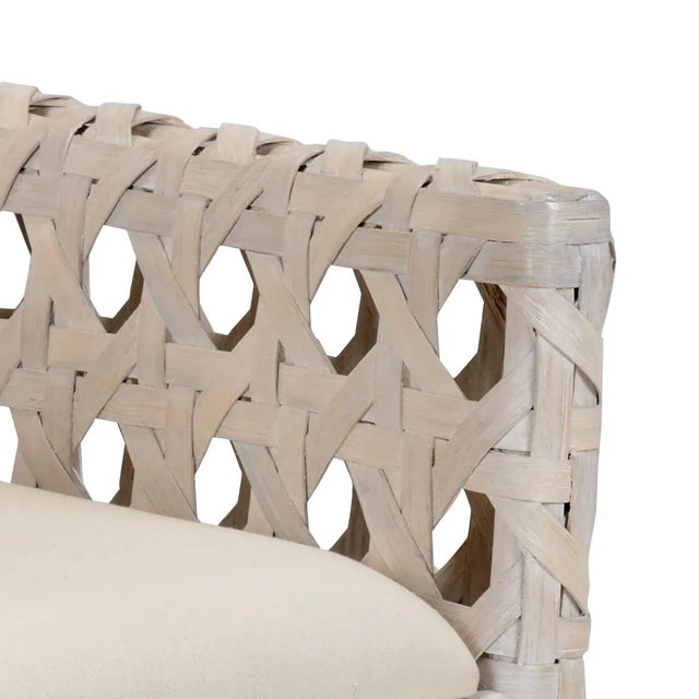Whitewash finish on rattan chair with off white woven fabric cushion