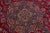 Beautiful Antique Kashan hand-knotted wool rug with a red color field. This Persian rug has a blue designed frame with...
