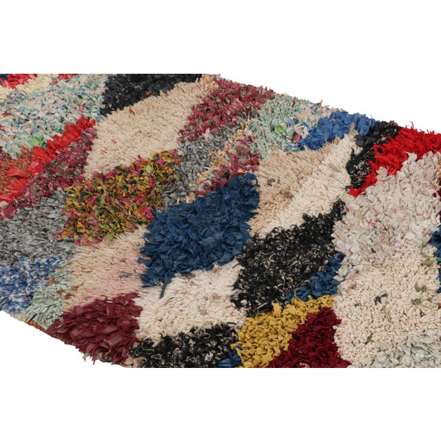 Hand-knotted in wool and originating from Morocco circa 1950-1960, this 3x6 vintage Moroccan rug is an extremely rare...