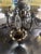 Ten light vintage hurricane style chandelier with amber crackle glass chimneys and a dark wood frame, chandelier arms are...