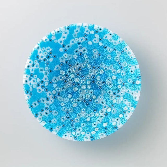 Murano glass bowl made by melting together sections of glass rods in a furnace, with each section depicting a small...