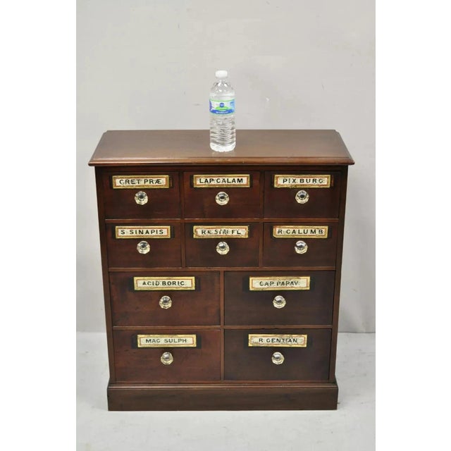 19th C. Victorian Mahogany Apothecary Medicine Cabinet w/ 10 Drawers and Glass Pulls. Item features original glass drawer...