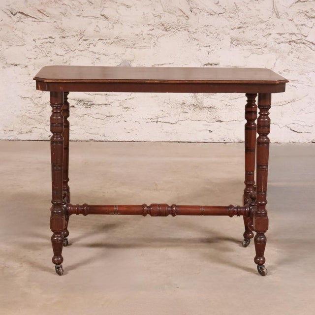 This 19th Century English Walnut Turned Leg Writing Table is a refined antique piece showcasing the timeless craftsmanship...